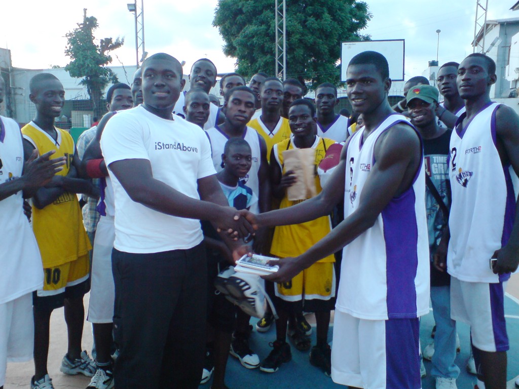 Hoops Captain, Saykan Bestman, receiving the donation.